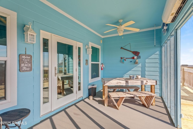 sunroom / solarium with ceiling fan and a wall unit AC