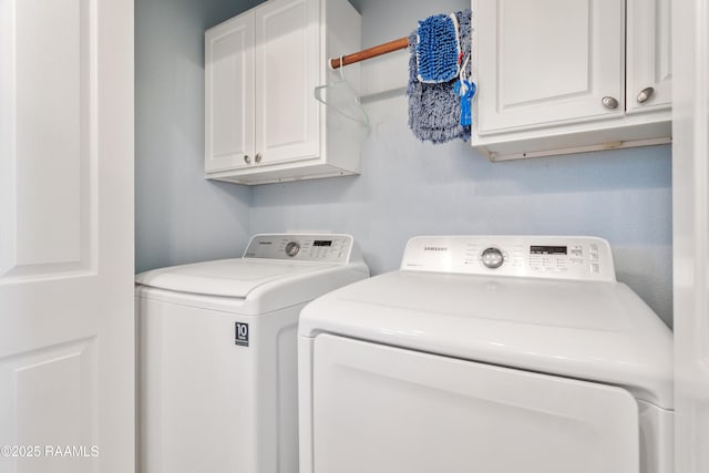 washroom featuring cabinets and washer and dryer