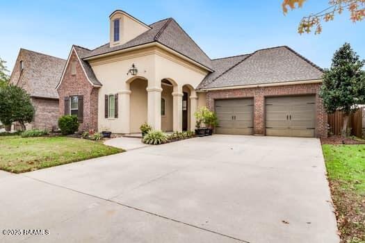 view of front of home with a garage and a front lawn