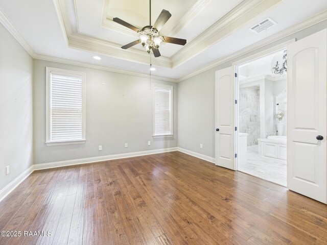 208 Rue De Frejus, Broussard, LA 70518 - empty room with crown molding, ceiling fan, wood-type flooring, a tray ceiling, and baseboards