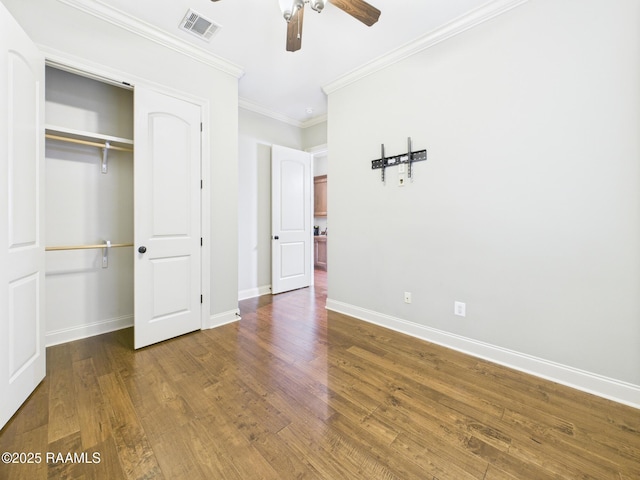 208 Rue De Frejus, Broussard, LA 70518 - unfurnished bedroom featuring baseboards, wood finished floors, crown molding, a closet, and a ceiling fan