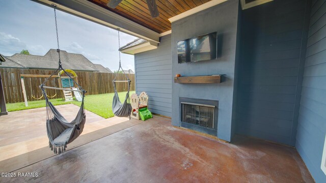 208 Rue De Frejus, Broussard, LA 70518 - fenced backyard featuring a fireplace, a patio, and a ceiling fan