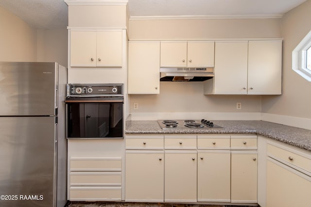 kitchen featuring black oven, a textured ceiling, stainless steel fridge, and gas stovetop