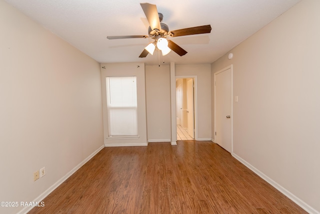 spare room with ceiling fan and wood-type flooring