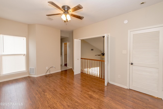 spare room with ceiling fan and wood-type flooring