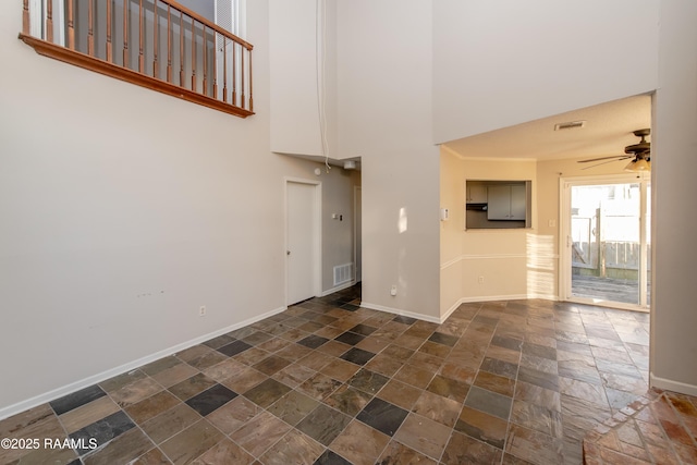 unfurnished living room with ceiling fan