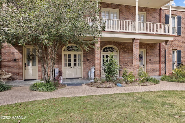 view of front of house with a balcony, a porch, and a front lawn