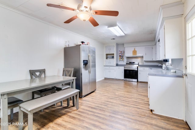 kitchen featuring sink, crown molding, light wood-type flooring, appliances with stainless steel finishes, and white cabinets