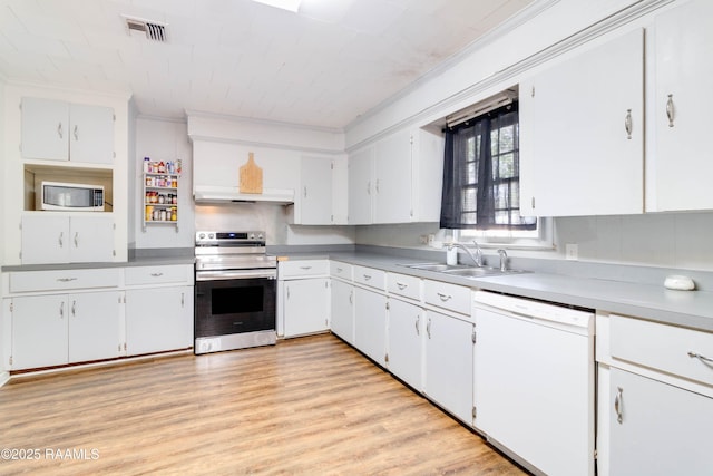 kitchen featuring white cabinetry, sink, white appliances, and light hardwood / wood-style flooring