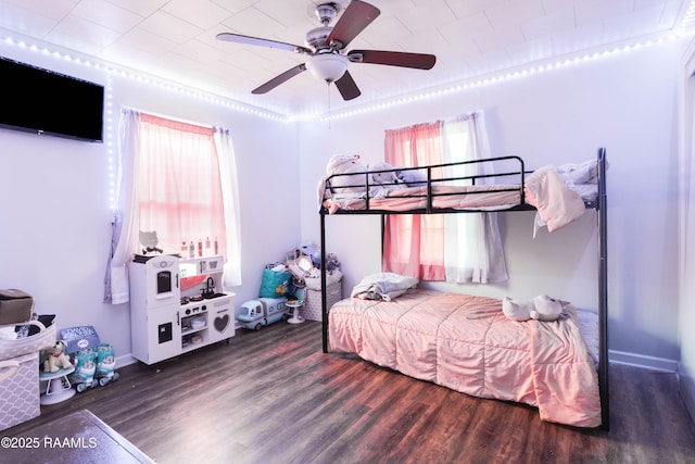 bedroom with dark hardwood / wood-style floors and ceiling fan