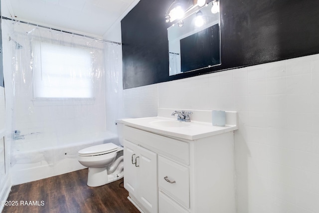 full bathroom featuring toilet, tile walls, vanity, shower / bath combo, and hardwood / wood-style floors