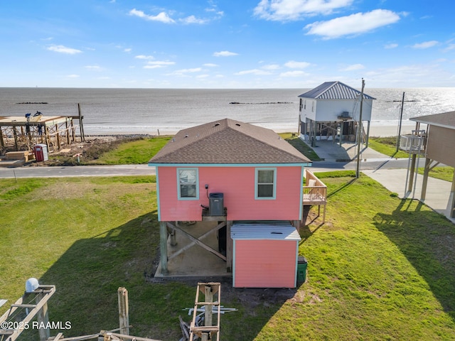 back of property featuring a water view