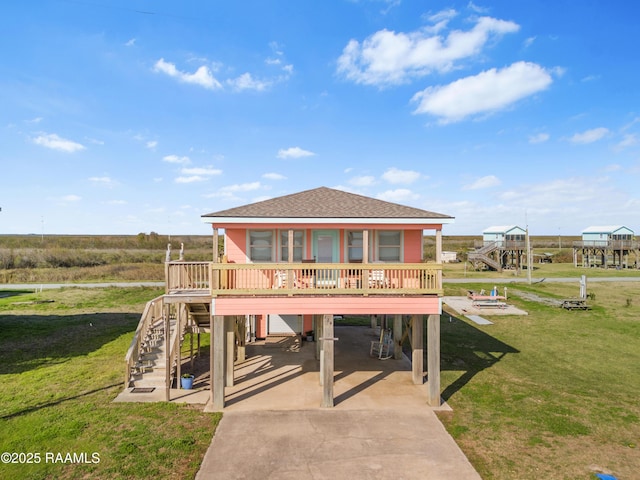 view of front of house featuring a front lawn, a carport, and a porch