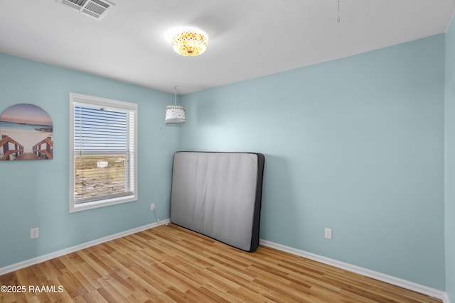 unfurnished room with light hardwood / wood-style flooring