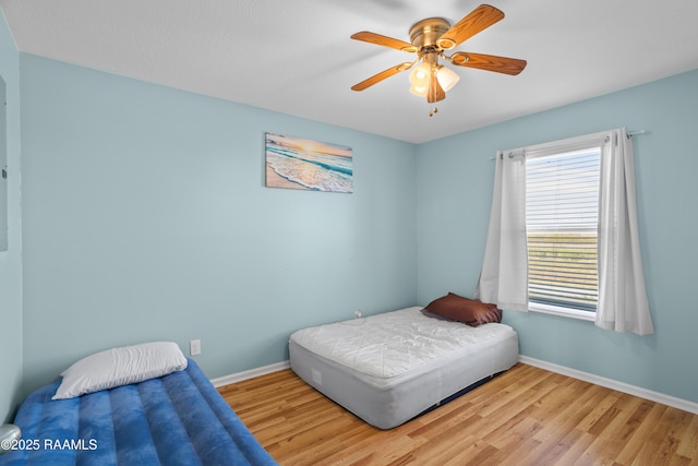 bedroom featuring light wood-type flooring and ceiling fan