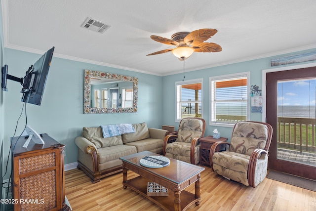 living room with crown molding and light wood-type flooring