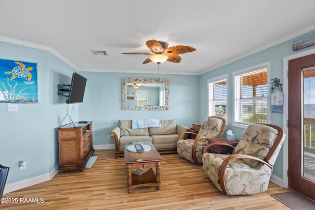 living room with crown molding, ceiling fan, and light wood-type flooring