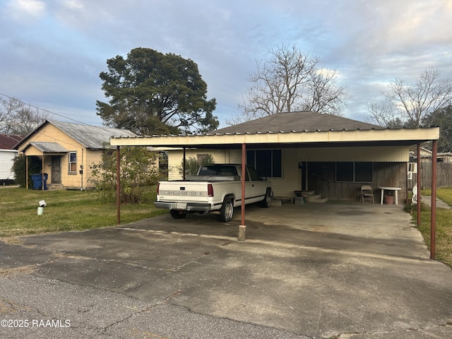 view of front of house with a carport and a front lawn