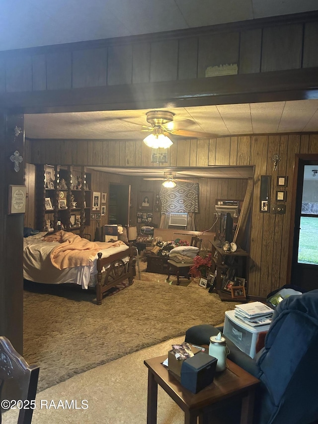 carpeted living room with ceiling fan and wood walls