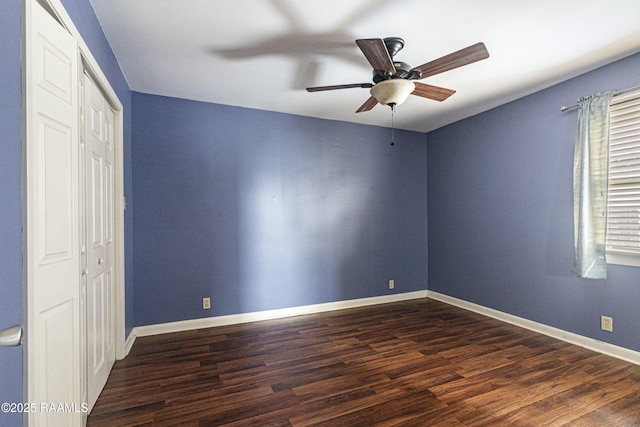 unfurnished bedroom featuring ceiling fan and dark hardwood / wood-style flooring