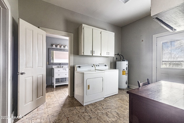 laundry room with cabinets, water heater, and washing machine and clothes dryer