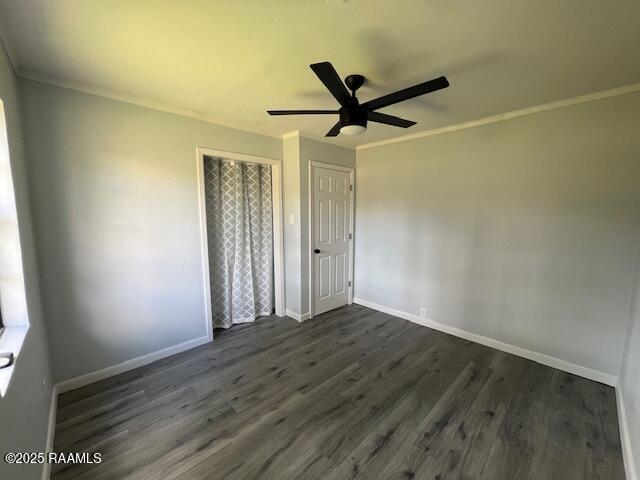 unfurnished bedroom with dark hardwood / wood-style floors, ceiling fan, and ornamental molding