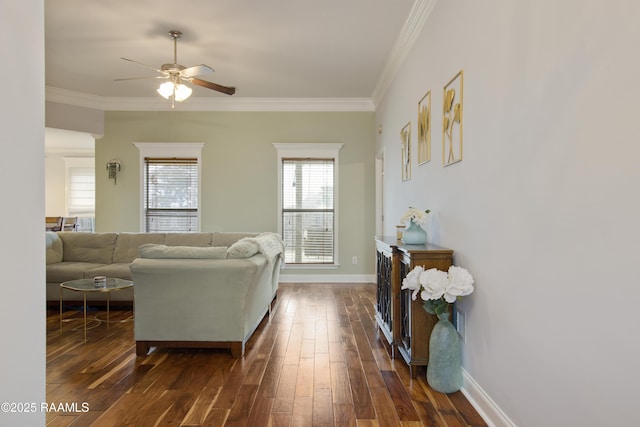 living room featuring dark hardwood / wood-style flooring, crown molding, and ceiling fan