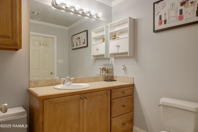 bathroom featuring crown molding, vanity, and toilet