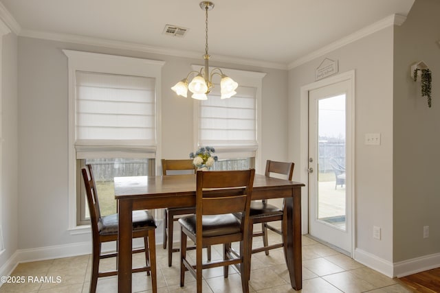 dining room with light tile patterned flooring, ornamental molding, an inviting chandelier, and plenty of natural light