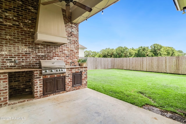 view of patio / terrace featuring sink, area for grilling, and ceiling fan