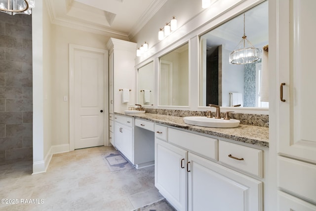 bathroom with vanity, a notable chandelier, and crown molding