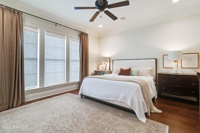 bedroom featuring ceiling fan, crown molding, and dark hardwood / wood-style floors