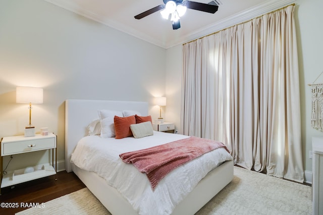 bedroom with ornamental molding, ceiling fan, and hardwood / wood-style flooring