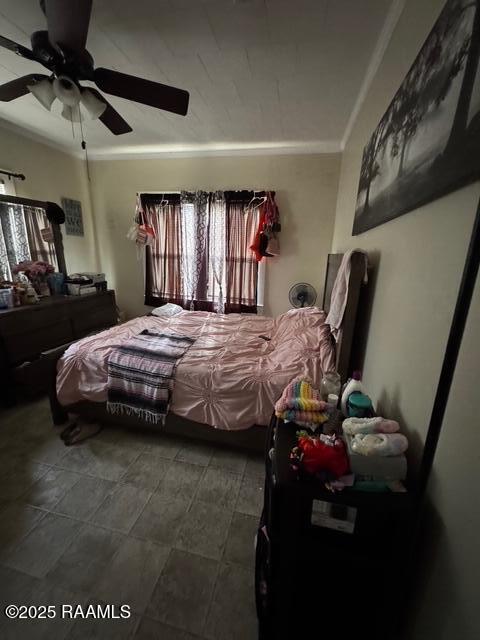 bedroom with ceiling fan and crown molding