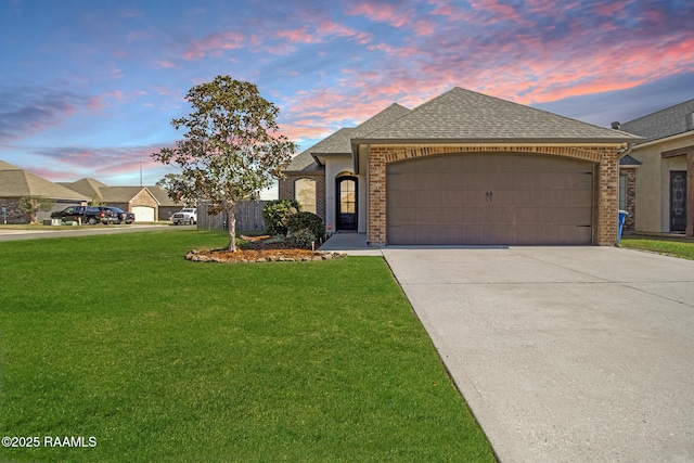 view of front of home featuring a yard and a garage