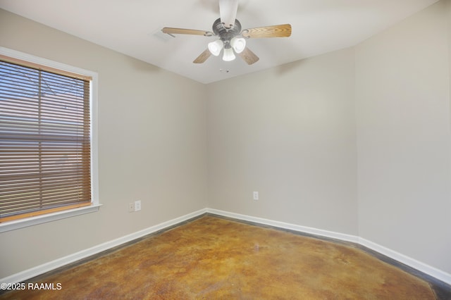 empty room featuring ceiling fan and concrete floors