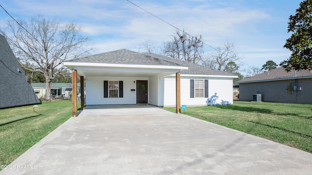 view of front of property with a carport, central AC, and a front yard