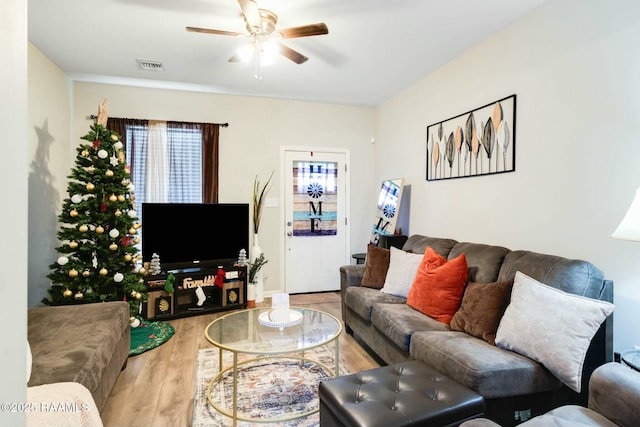 living room featuring ceiling fan, hardwood / wood-style flooring, and plenty of natural light