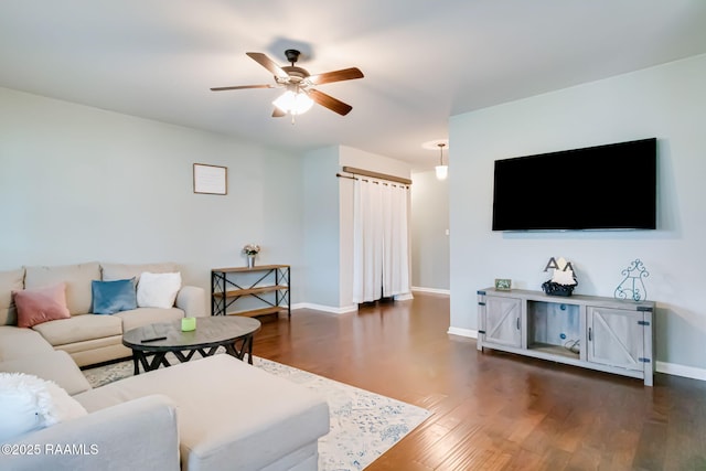 living room featuring dark hardwood / wood-style floors and ceiling fan