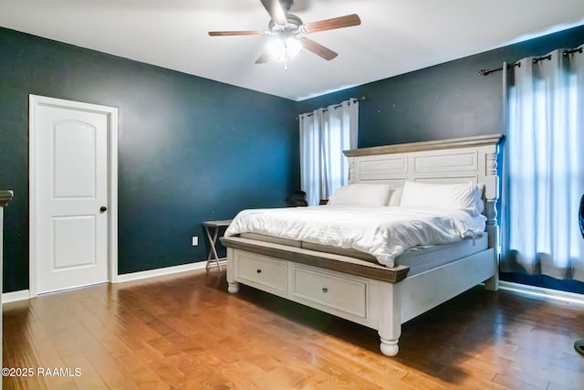 bedroom with hardwood / wood-style flooring and ceiling fan