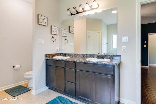 bathroom with vanity, tile patterned flooring, and toilet