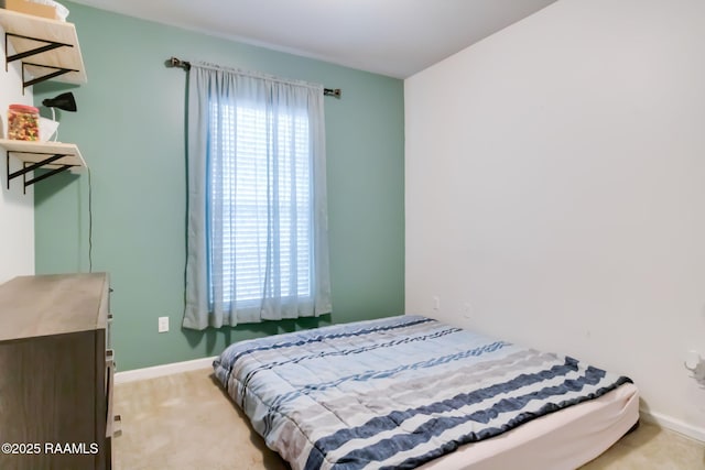 bedroom featuring light carpet and multiple windows