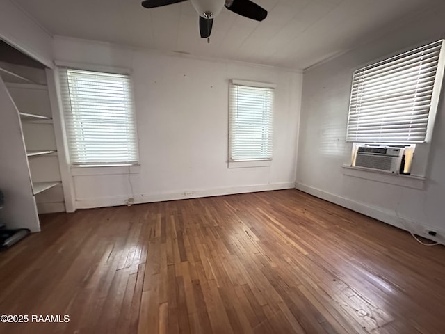 unfurnished bedroom with wood-type flooring, ceiling fan, and cooling unit