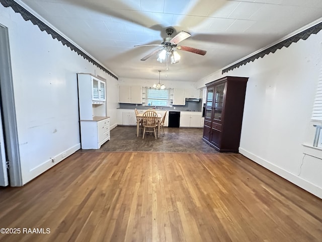 kitchen featuring range hood, dark hardwood / wood-style floors, white cabinetry, ceiling fan with notable chandelier, and black dishwasher