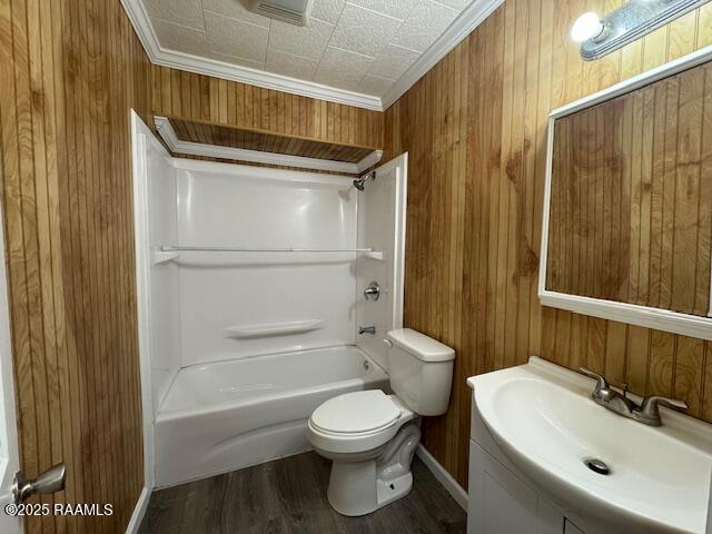 full bathroom with vanity, crown molding, hardwood / wood-style floors, and wooden walls