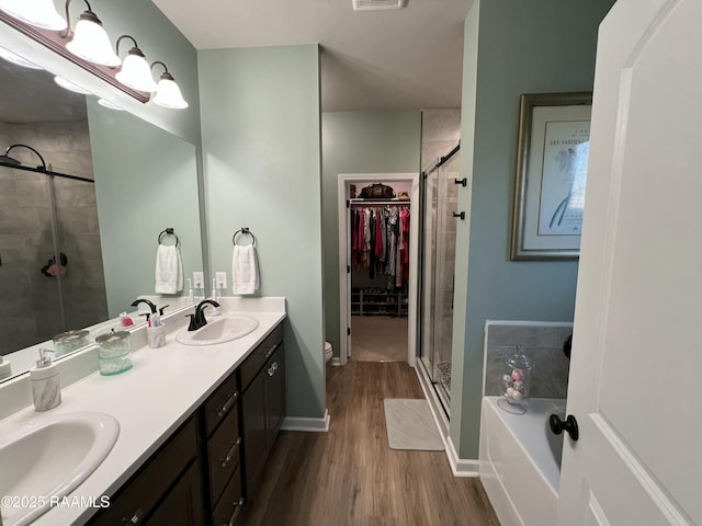 full bathroom featuring hardwood / wood-style floors, toilet, vanity, and plus walk in shower