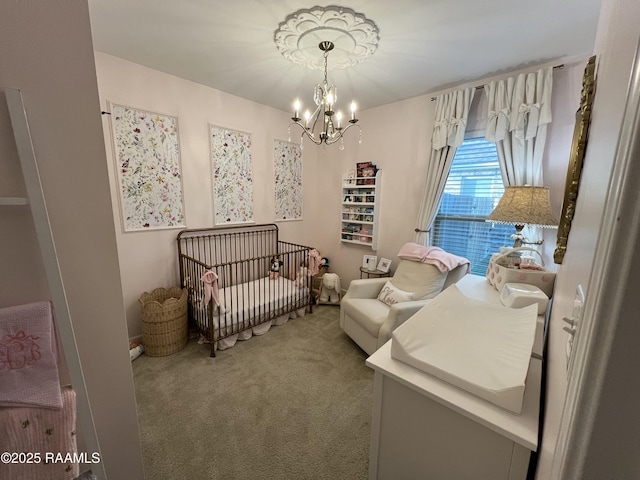 bedroom featuring carpet, a nursery area, and an inviting chandelier