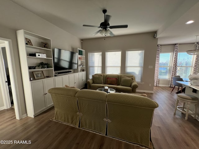 living room with ceiling fan and dark wood-type flooring