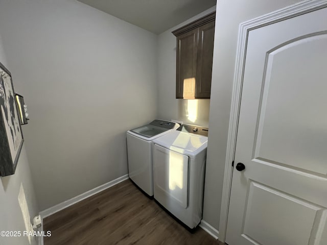 laundry room featuring cabinets, separate washer and dryer, and dark hardwood / wood-style floors