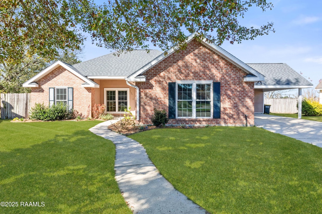 view of front of property with a front yard and a carport